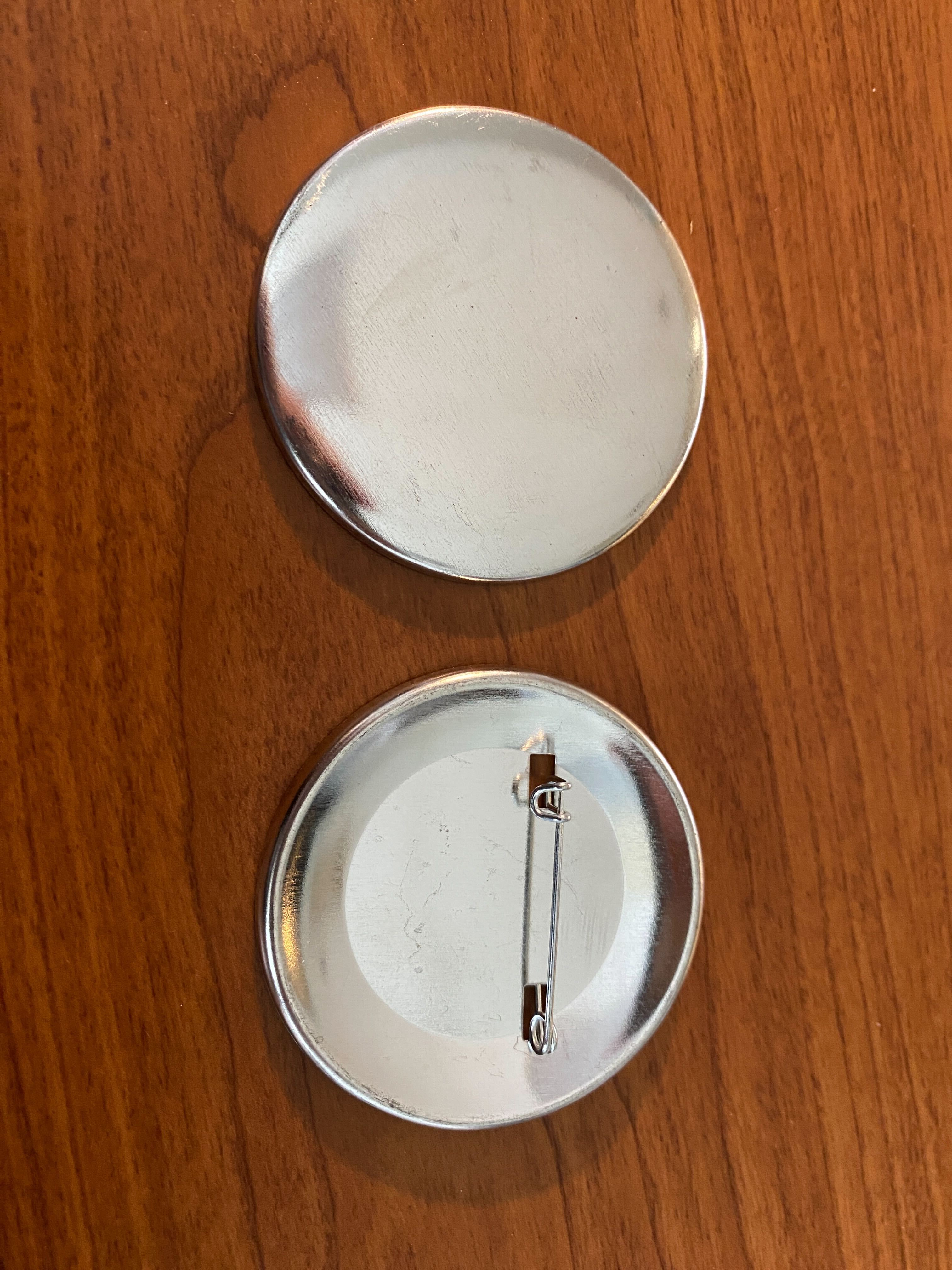 Pin backs and fronts Reaching Across Illinois Library System