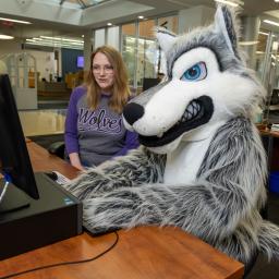 Wiley the Wolf and Library at Reference Desk