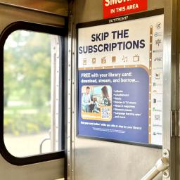 An ad displays at the entrance of a Metra train