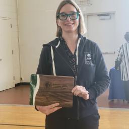 Director holding plaque