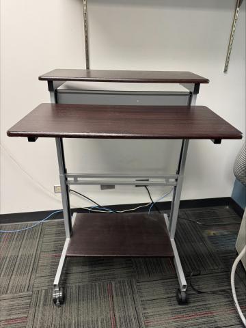 standing computer desk with dark brown laminate top