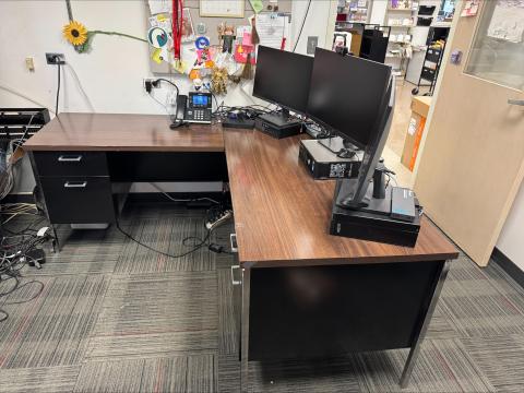 L-shaped desk with wood laminate top and black sides