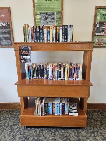 Display shelving unit with three shelves where the books can be accessed from the front and back.
