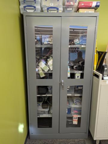 A gray metal cabinet with glass doors.