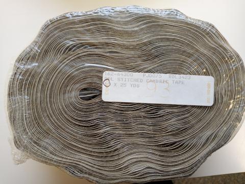 A roll of cream Demco 1-inch double-stitched cambric tape