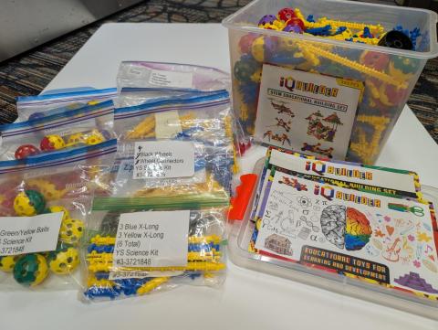 A tub of building pieces and 8 small storage bags of additional building pieces.
