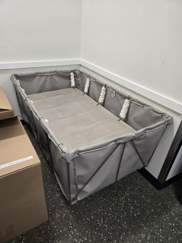 Oversize book drop with suspended tray