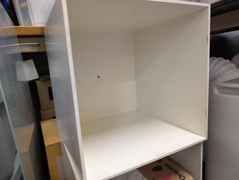 A white, cube-shaped storage box