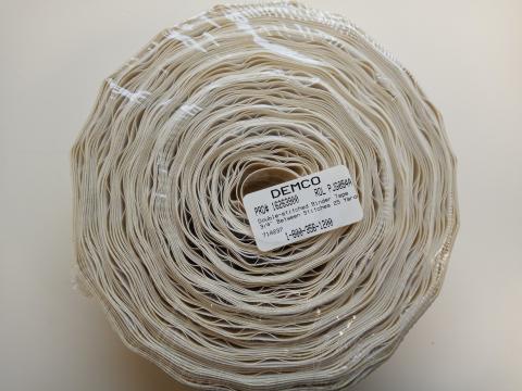 A roll of cream Demco 3/4-inch double-stitched binder tape