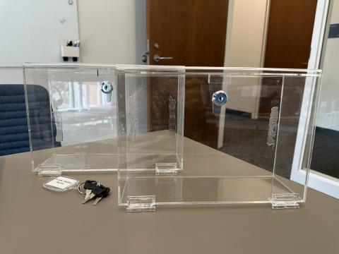 Two small boxes made of acrylic and keys