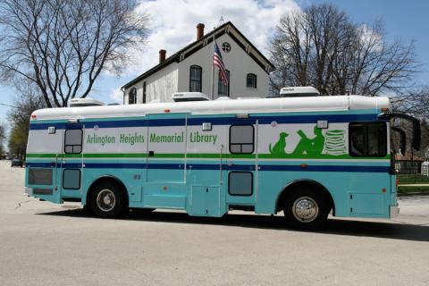 blue and green bookmobile on the road