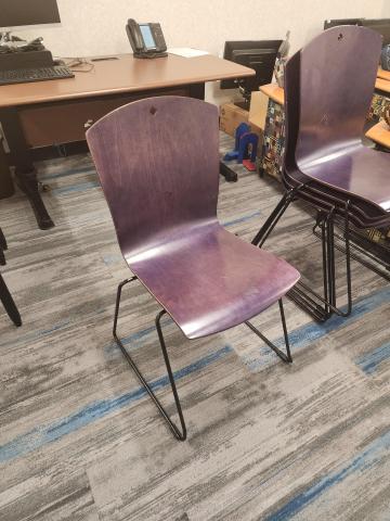 Wooden chair in blue stain with small diamond cutout and metal sled base in black.