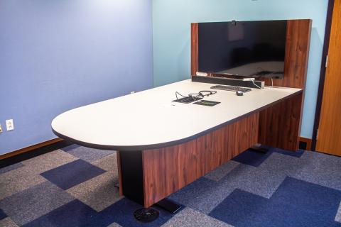 White/gray laminate top tapered rectangle rounded end table with high dark wood back