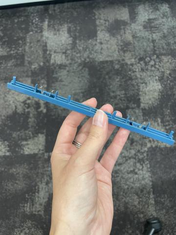 Security lock for DVD cases. Blue lock with metal prongs and plastic. Front of security lock reads "Security Case". 