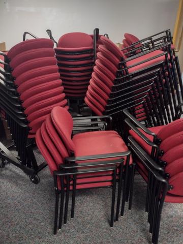 5 stacks of red fabric chairs