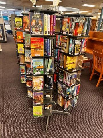 Six spinner racks holding mass market paperback books. Each rack holds 350-400 books.