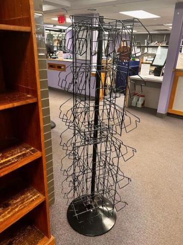 Five foot tall black wire spinner rack with round base. Four sides. Each side holds 24 paperback books.