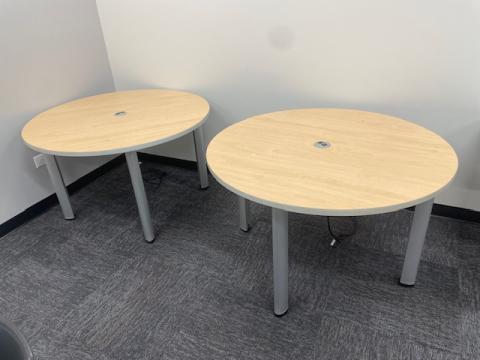 2 round light colored tables with silver legs