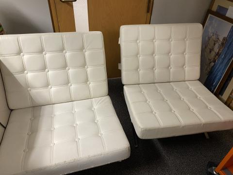 2 white barcelona style chairs