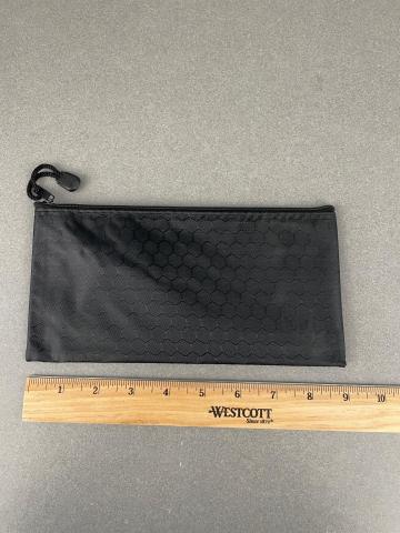small black pouch, next to a ruler showing the length of the pouch to be 9 inches