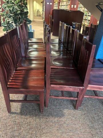 Set of multiple cherry wood chairs.