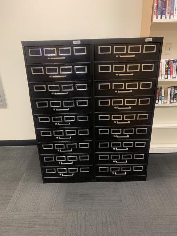 2 black metal microfilm cabinets