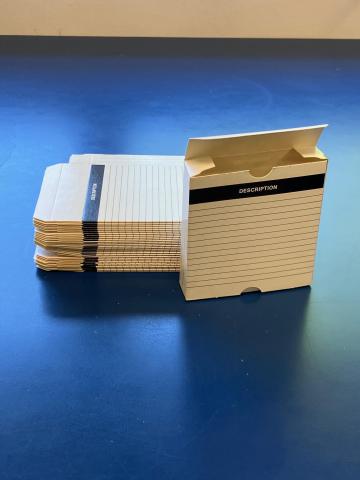 Image is of an empty white microfilm storage carton.