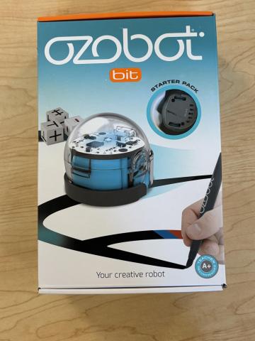Ozobot Bit Starter Kit in teal and white box on a wooden table
