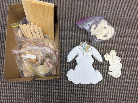 assorted wood crafts in box, wood bunny craft, wood lizard craft, wooden anchors in a plastic bag