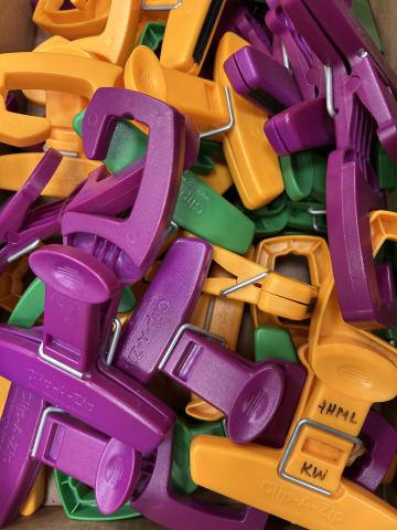 purple, green, and orange plastic clips with hooks