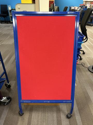 red felt covered whiteboard on wheels
