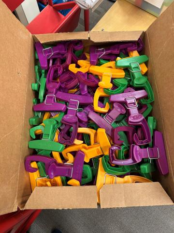 purple, green, and orange plastic clips with hooks