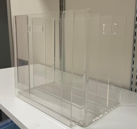 Clear acrylic magazine / periodical storage box on white shelf.