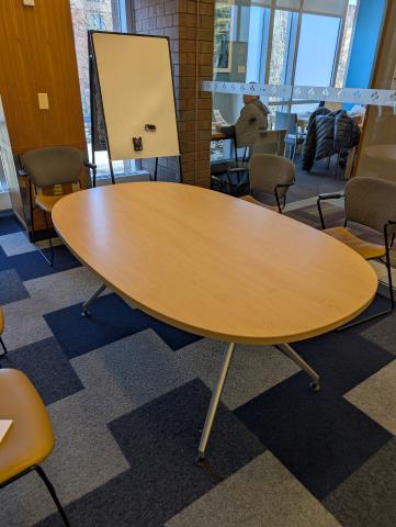 Laminate wood top ovel table with metal legs