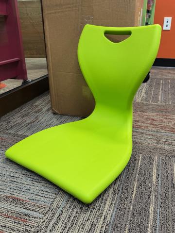 A picture of a floor seat in a lime green shade