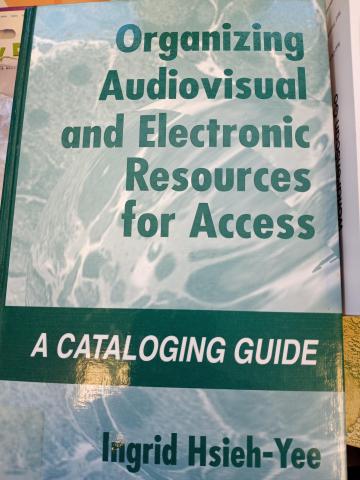 The marbled cover of a book with "Organizing Audiovisual and Electronic Resources for Access" in green