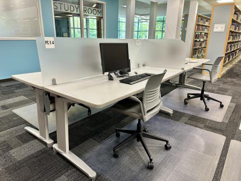 gray table with computer sitting on it