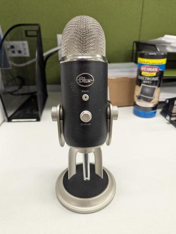 A black and silver blue yeti microphone 