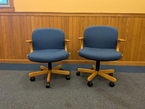 Two blue chairs that swivel