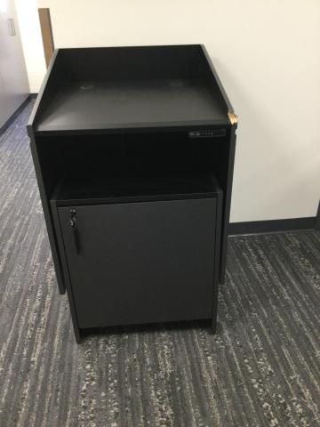 Picture of dark grey electric lift podium on wheels