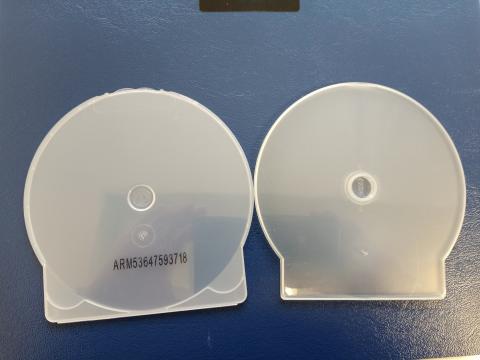 Two types of round white plastic cases for discs on a blue background