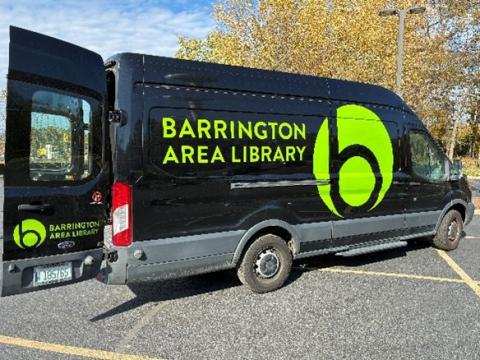 A black van with yellow writing on it