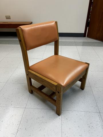 child-sized wooden chair with apricot colored vinyl