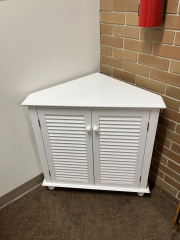 white corner cabinet with two doors