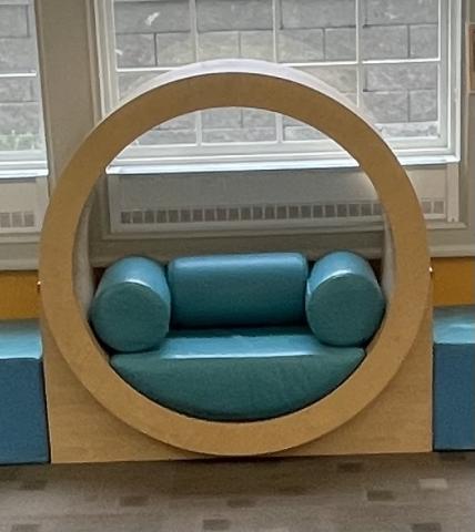 Image of a wooden circular chair with cushion