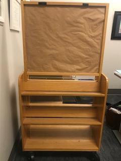 This book display cart is double-sided and on wheels. The dimensions are: 38"(h)x32"(l)x15"(w). There is also an attached sign holder that is 26"(h)x30"(l).