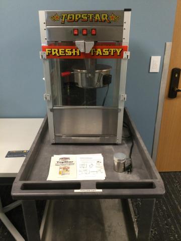 Photo of a popcorn machine and rolling cart