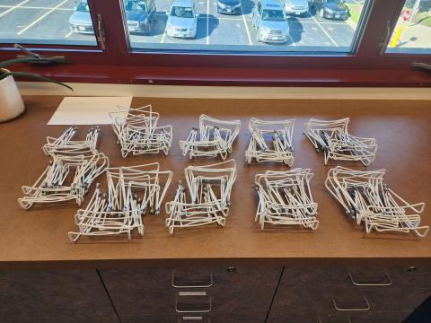 view of 9 stacks of 10 easels each plus 4