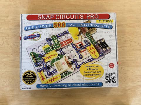 Snap Circuits Pro kit in a white box on a wood table