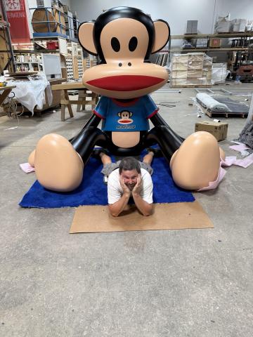 Photo of Julius Monkey prop with man in front of prop